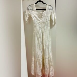White eyelet dress with cutouts for summer, long flowy fabric.